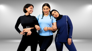 three young ladies in blue and black activewear. One wearing hijab, one wearing longsleeves sports bra and another wearing a short sleeve exercise top.